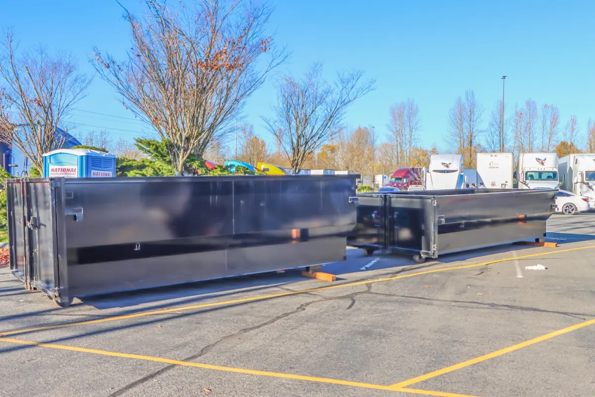 Professional dumpster rental service with roll-off container on residential driveway in Fallon